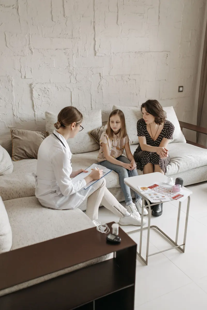 Doctor in a consultation with a mother and her daughter